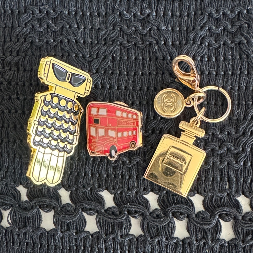 Pin set and charm. Chanel, Paco Rabanne, Burberry red London bus.